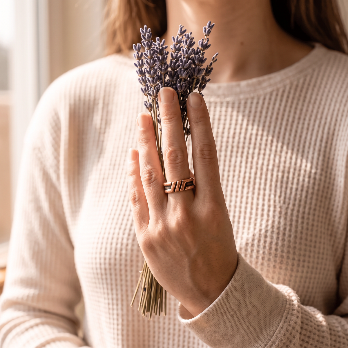 Oriana copper ring worn on the finger, holding dried lavender