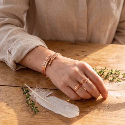 Feather cuff and ring worn together by a woman
