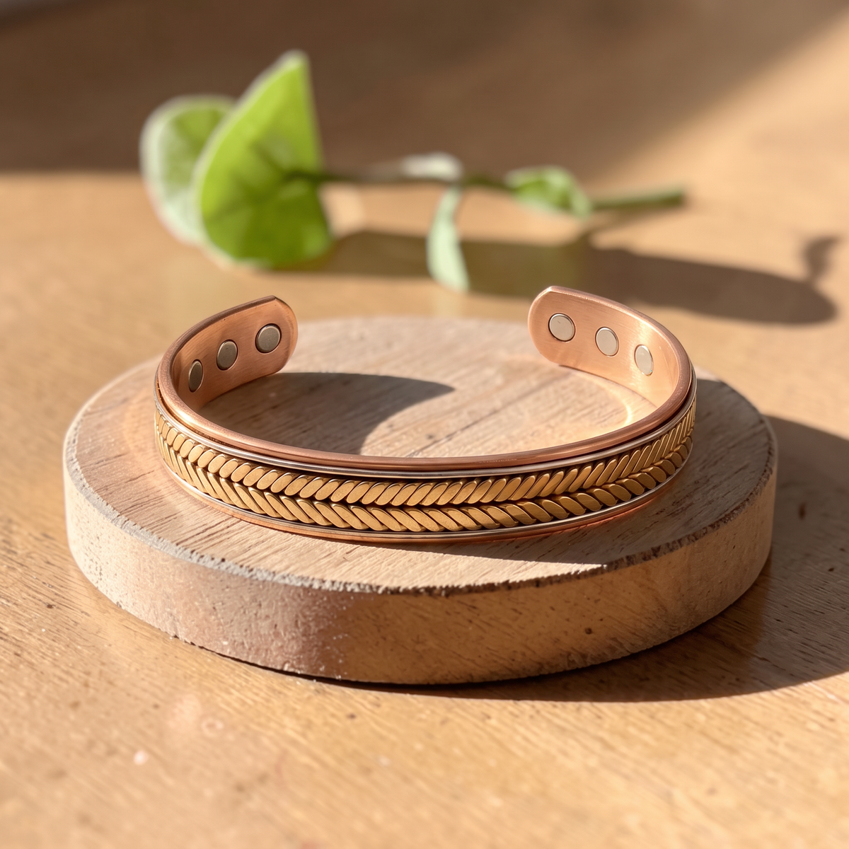 Ella's Opaline copper and brass bracelet on a wooden disc