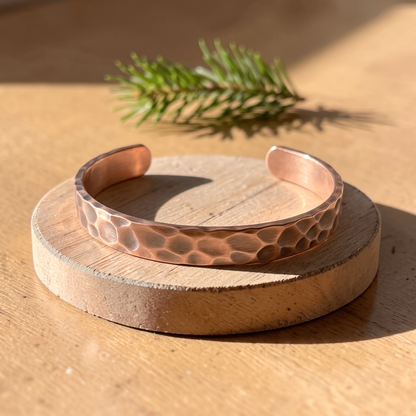 Ella's Lodester hammered copper cuff on a wooden disc