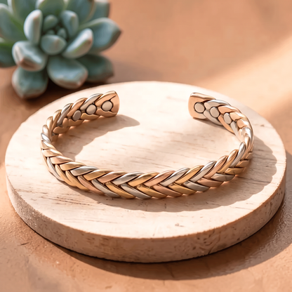 Ella's Stone braided copper, brass and silver cuff on a wooden disc
