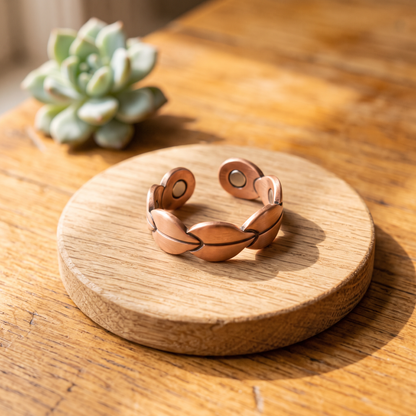 Ella's Marsh copper ring on a wooden disc