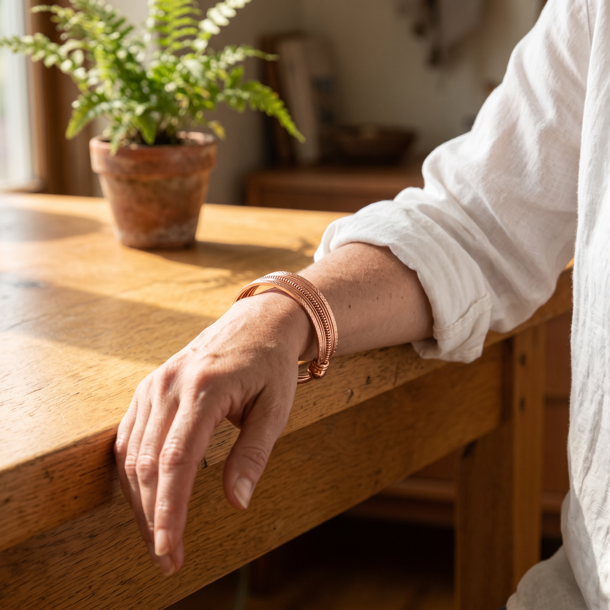 Ivory copper cuff worn on the wrist