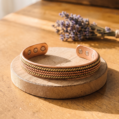 Ella's River copper and brass rope cuff on a wooden disc